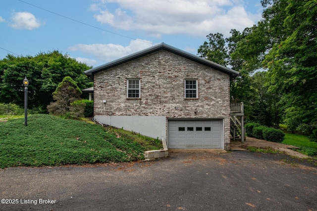 4217 Deckard School Rd, Radcliff, KY 40160 - view of home's exterior with driveway, a garage, brick siding, and stairway