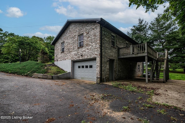 4217 Deckard School Rd, Radcliff, KY 40160 - view of property exterior featuring stairway, a deck, a garage, driveway, and brick siding
