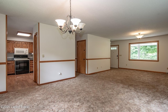 4217 Deckard School Rd, Radcliff, KY 40160 - unfurnished living room featuring light colored carpet, baseboards, and a chandelier