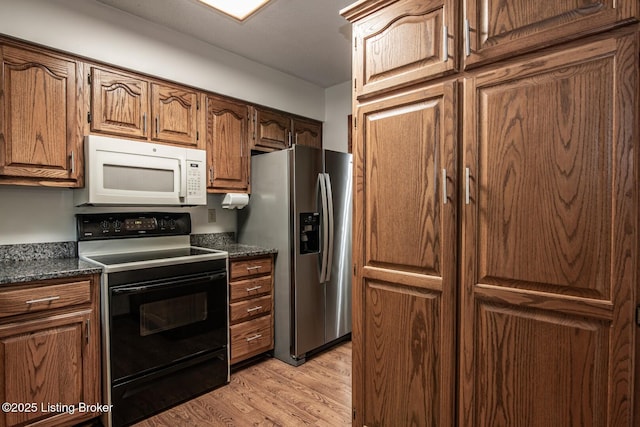 4217 Deckard School Rd, Radcliff, KY 40160 - kitchen with white microwave, black electric range, stainless steel refrigerator with ice dispenser, light wood-style flooring, and brown cabinetry