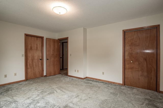 4217 Deckard School Rd, Radcliff, KY 40160 - unfurnished bedroom featuring carpet floors, baseboards, multiple closets, and a textured ceiling