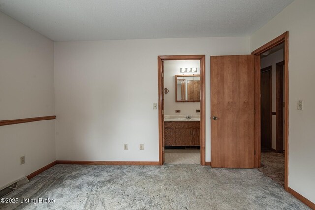 4217 Deckard School Rd, Radcliff, KY 40160 - unfurnished bedroom featuring carpet, a sink, baseboards, and connected bathroom