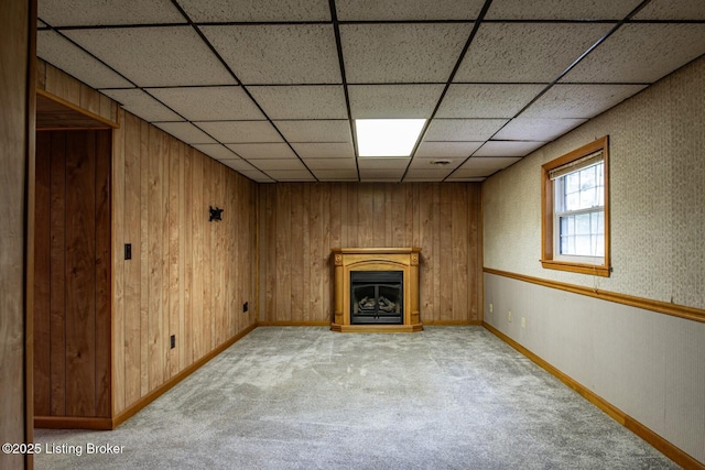 4217 Deckard School Rd, Radcliff, KY 40160 - unfurnished living room featuring light colored carpet, baseboards, a drop ceiling, wood walls, and a fireplace