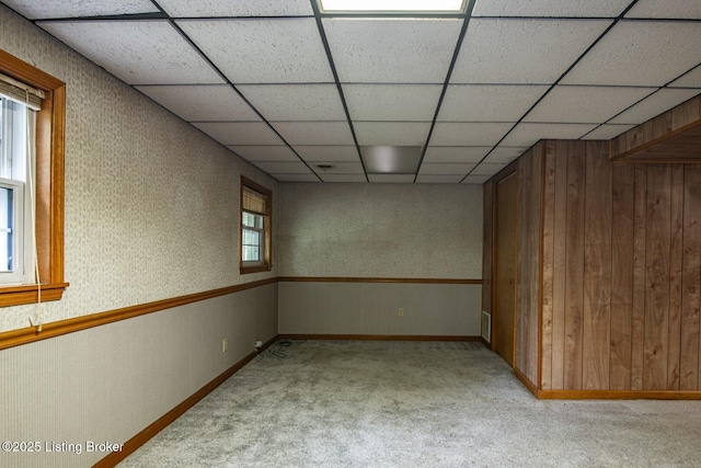 4217 Deckard School Rd, Radcliff, KY 40160 - unfurnished room with light colored carpet, plenty of natural light, wooden walls, baseboards, and a drop ceiling
