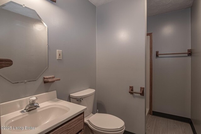 4217 Deckard School Rd, Radcliff, KY 40160 - bathroom with toilet, vanity, wood finished floors, and a textured ceiling