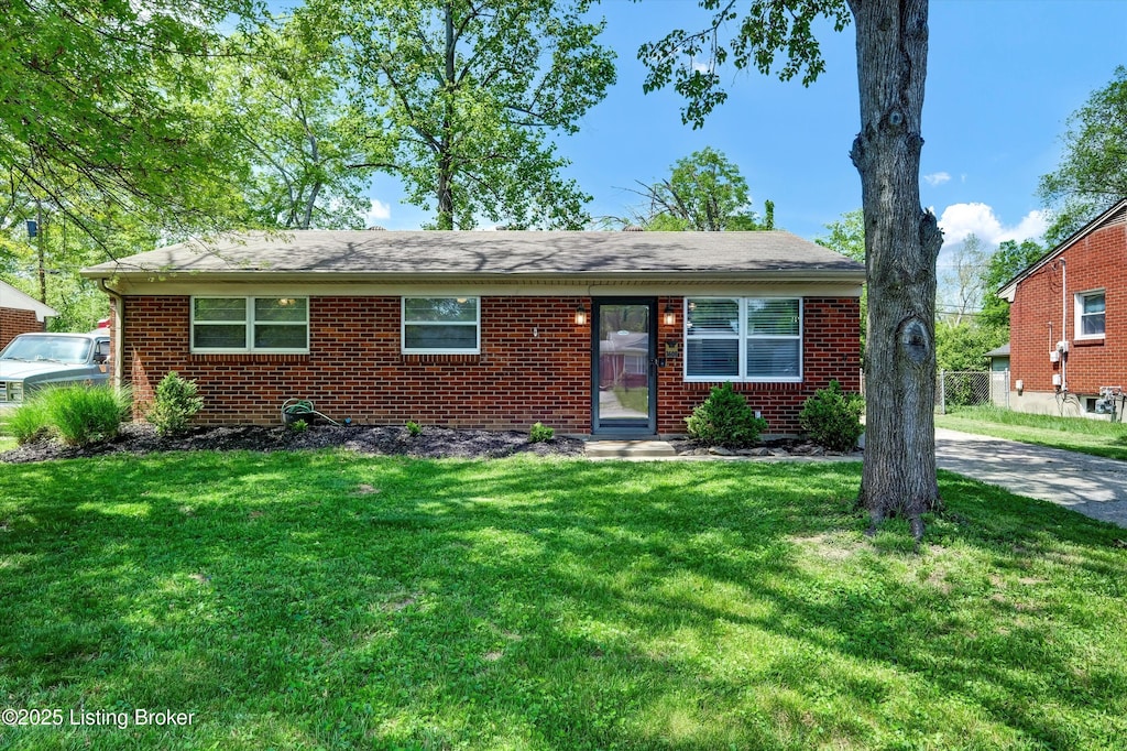ranch-style home with brick siding and a front yard