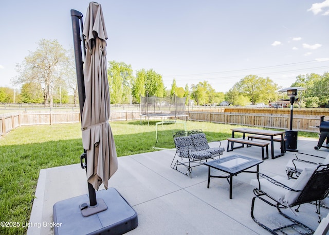 view of patio / terrace with a trampoline and a fenced backyard