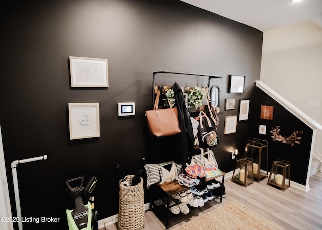 interior space with wood finished floors and baseboards
