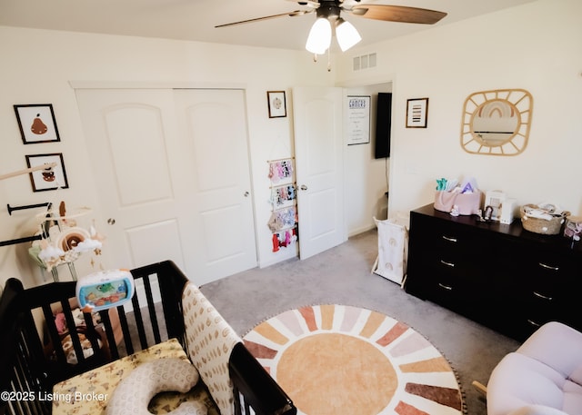 carpeted bedroom with visible vents, ceiling fan, and a closet