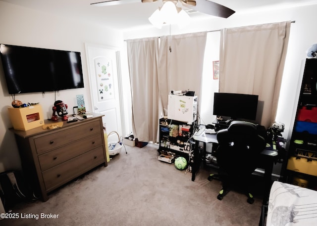 office area with a ceiling fan and light colored carpet