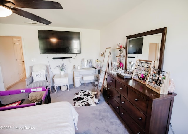 carpeted bedroom with visible vents and a ceiling fan