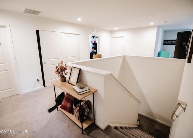 staircase with visible vents, recessed lighting, and carpet floors