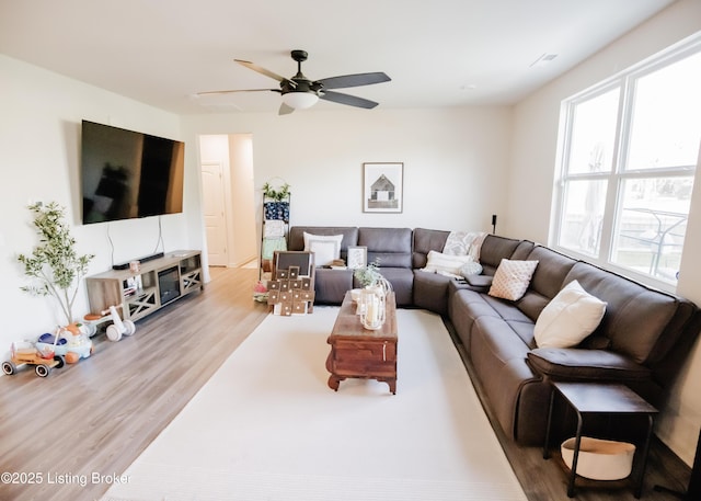 living room with wood finished floors and ceiling fan