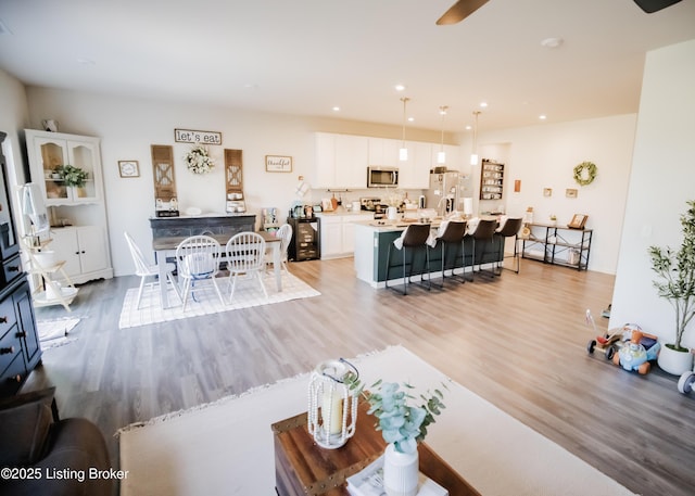 living room featuring light wood-type flooring and recessed lighting