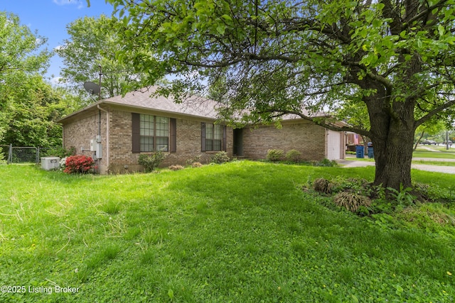 ranch-style home featuring brick siding, fence, a front yard, and roof with shingles