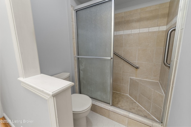 full bath featuring a stall shower and toilet