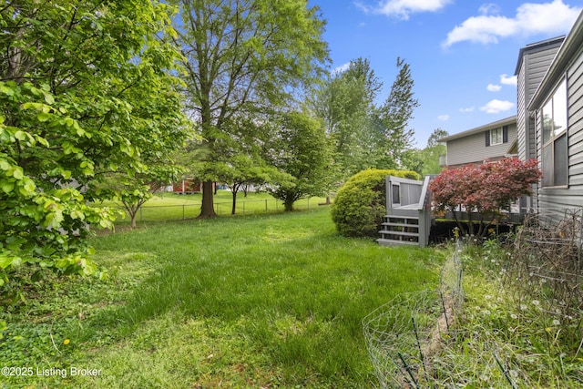 view of yard with fence and a wooden deck