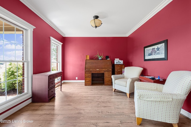 sitting room with crown molding, baseboards, a healthy amount of sunlight, and light wood-type flooring