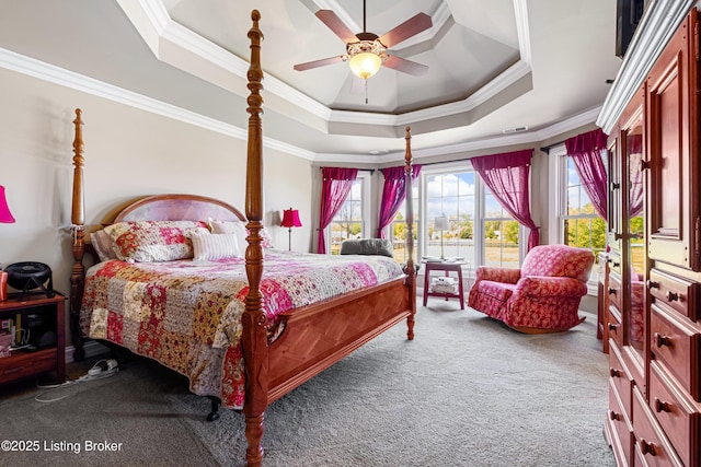 bedroom featuring carpet flooring, ceiling fan, a tray ceiling, and ornamental molding