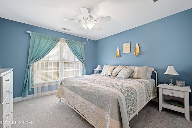 bedroom featuring visible vents, a ceiling fan, baseboards, and light carpet