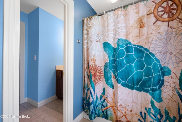 bathroom featuring vanity, baseboards, and tile patterned floors