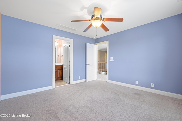 unfurnished bedroom featuring a ceiling fan, light colored carpet, visible vents, baseboards, and ensuite bathroom