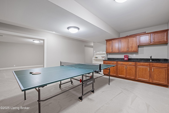 game room featuring a sink and light colored carpet