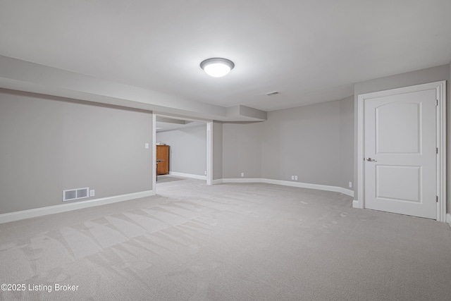 finished basement featuring visible vents, carpet, and baseboards