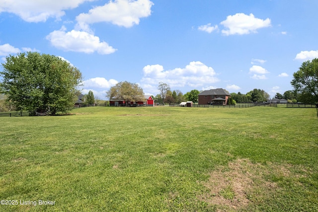 view of yard with fence and an outdoor structure
