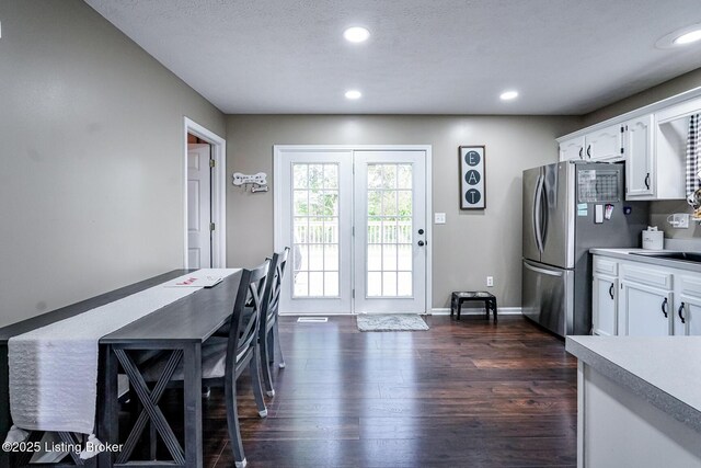 dining space with recessed lighting, dark wood-style flooring, and baseboards