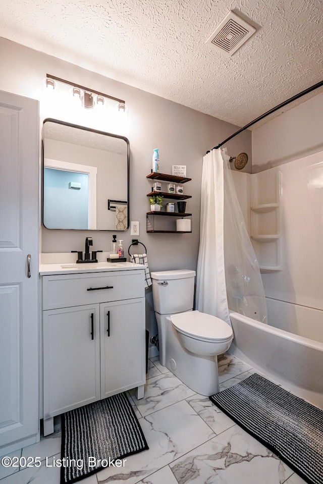 bathroom with marble finish floors, toilet, shower / bath combination with curtain, vanity, and a textured ceiling