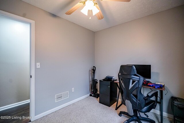 office space with a ceiling fan and baseboards
