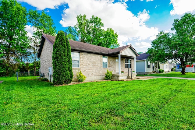 single story home with brick siding, a front lawn, and covered porch