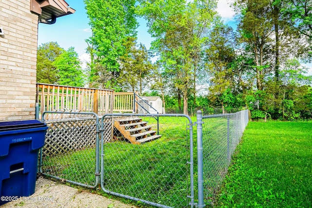 view of yard featuring a gate, a wooden deck, and a shed