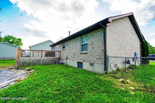 rear view of property featuring a deck, brick siding, and central AC unit
