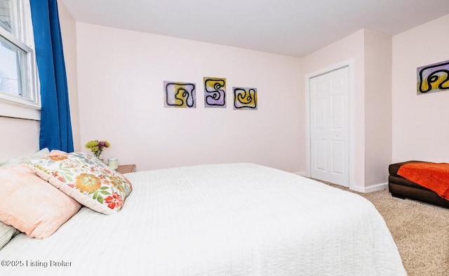 bedroom with carpet flooring and baseboards