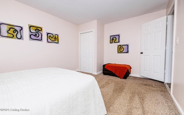 bedroom featuring a closet, carpet flooring, and baseboards