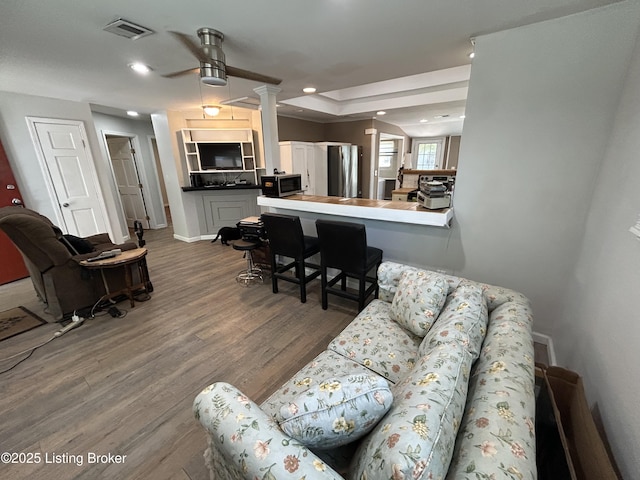 living room featuring dark wood finished floors, a ceiling fan, baseboards, recessed lighting, and visible vents