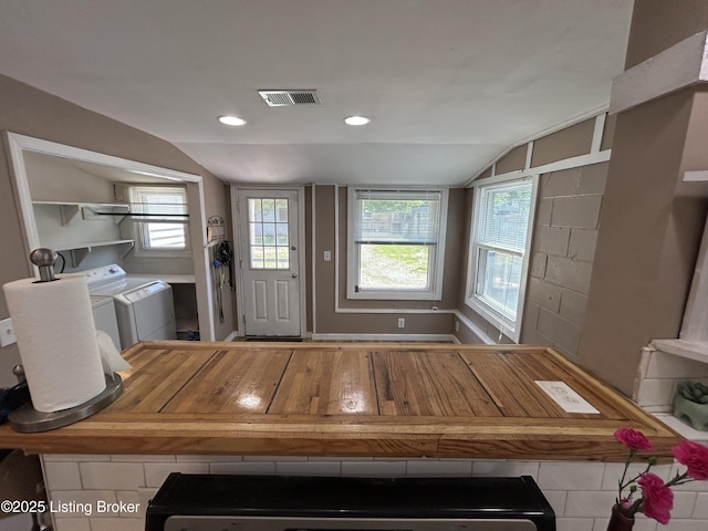 interior space with washer and dryer, recessed lighting, vaulted ceiling, and visible vents