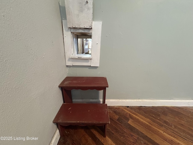 room details with baseboards and wood finished floors