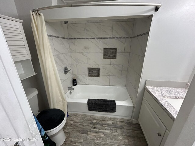 full bath with vanity, toilet, wood finished floors, and shower / tub combo