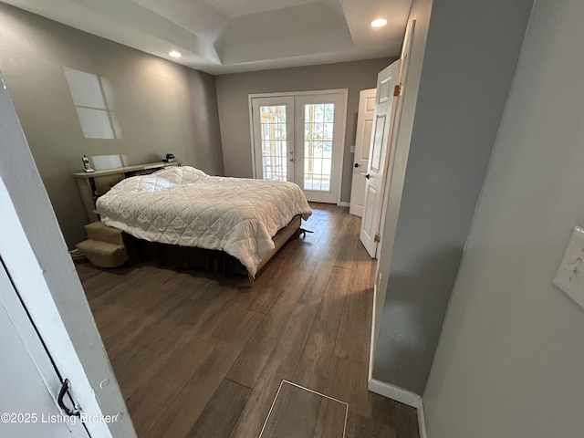 bedroom featuring access to outside, recessed lighting, a raised ceiling, and dark wood-style flooring