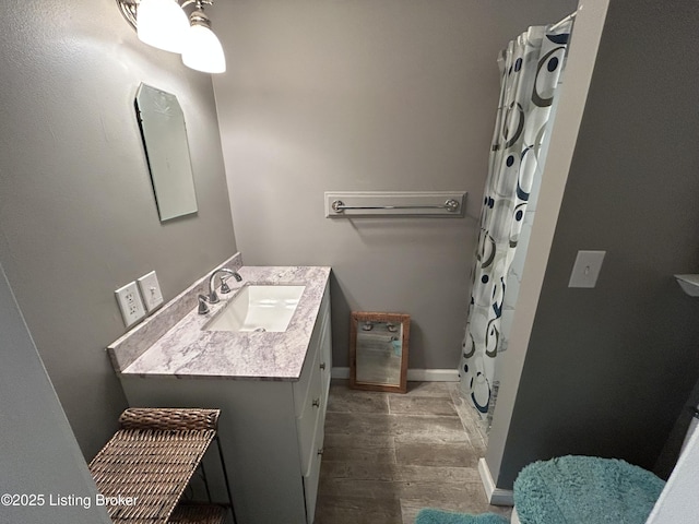 full bathroom featuring vanity, baseboards, and a shower with shower curtain