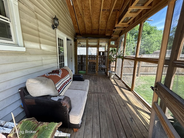 wooden deck with a fenced backyard