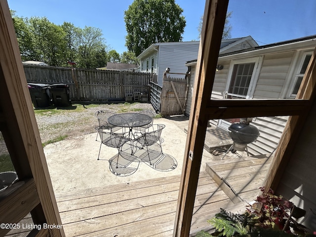 deck featuring outdoor dining area, a fenced backyard, and a patio area