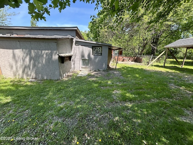 exterior space with fence and a yard