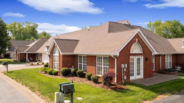 10436 Monticello Forest Cir, Louisville, KY 40299 - view of front of home with brick siding, french doors, roof with shingles, and a front lawn