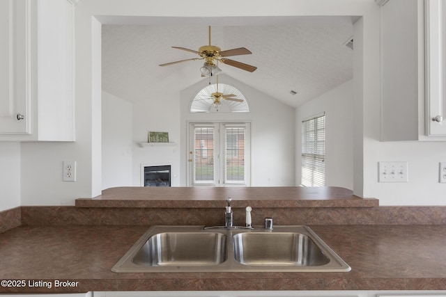 10436 Monticello Forest Cir, Louisville, KY 40299 - kitchen with a ceiling fan, dark countertops, a sink, white cabinets, and lofted ceiling