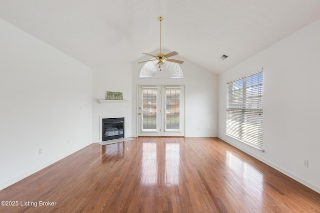 10436 Monticello Forest Cir, Louisville, KY 40299 - unfurnished living room featuring a ceiling fan, vaulted ceiling, a fireplace with flush hearth, and light wood finished floors