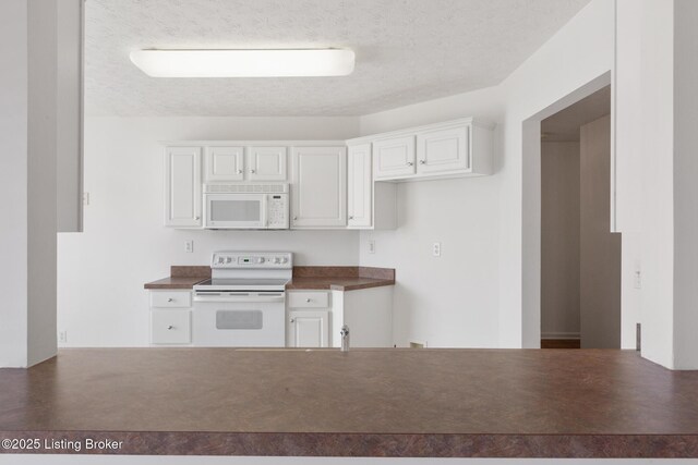 10436 Monticello Forest Cir, Louisville, KY 40299 - kitchen with dark countertops, a textured ceiling, white appliances, and white cabinetry